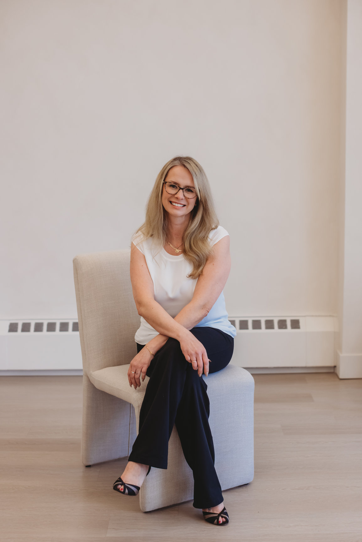 Sarah Hope, clinical counsellor, seated and smiling warmly in natural light